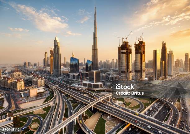 Spectacular Skyline Of Dubai Uae Futuristic Modern Architecture Of A Big City At Sunset With A Large Highway Intersection Stock Photo - Download Image Now