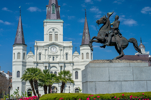a statue of general andrew jackson on horseback, faces the st.louise cathederal, in jackson square, new orleans, louisiana
