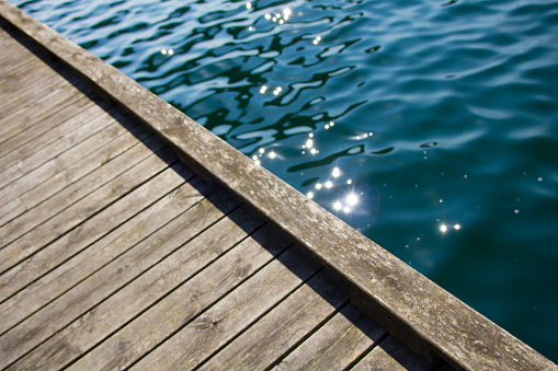 Old wooden jetty and vibrant blue turquoise water in an almost abstract diagonal composition.