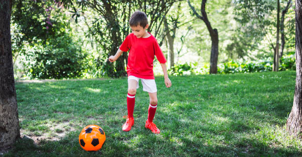 istock Boy play with football ball 669057582