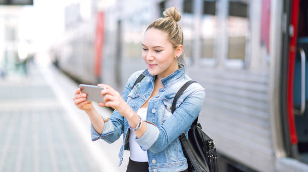 istock Beautiful young woman in real life using smartphone 669057894