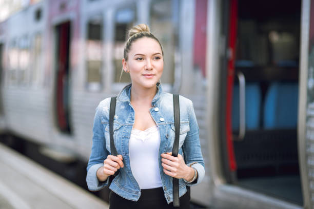 istock Woman traveler with backpack on rail station checking time 669057900