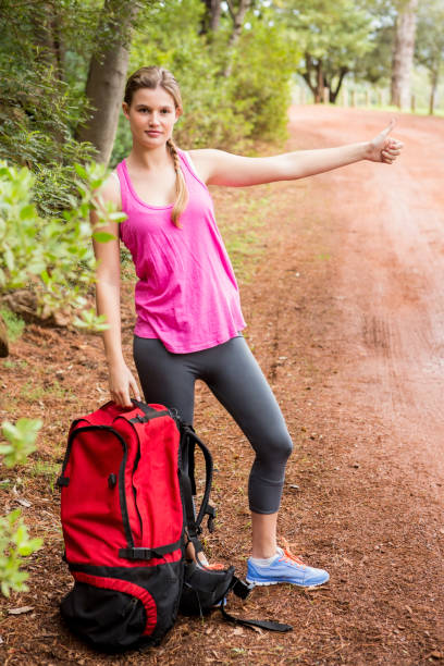 istock Pretty blonde with backpack hitchhiking 669060714