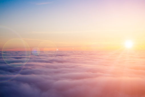 Aerial view of the clouds at sunset with lensflare effect