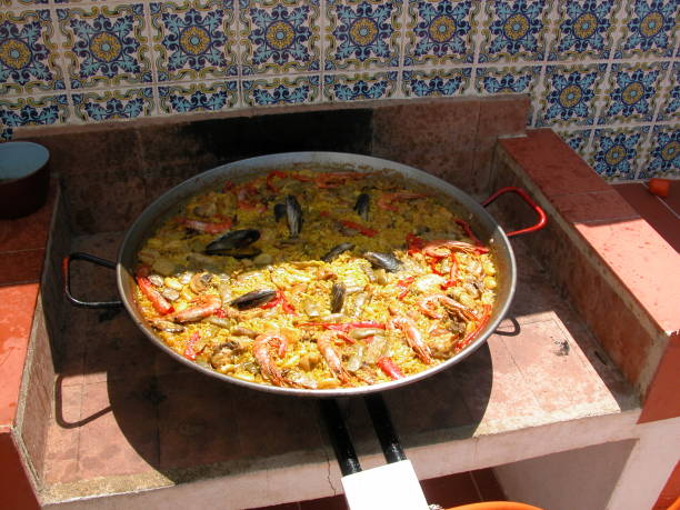 Paella in Spain Spain, paella, rice, yellow, saffron Artichoke stock pictures, royalty-free photos & images