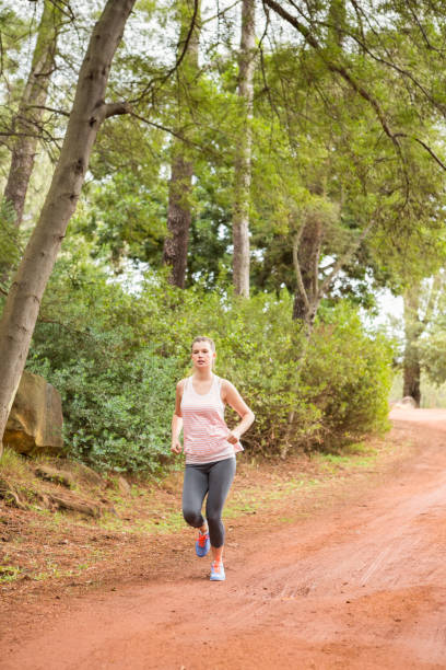 pretty blonde athlete jogging - running jogging footpath cross country running imagens e fotografias de stock