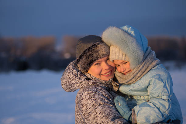 istock mother and daughter walking in park 669068108