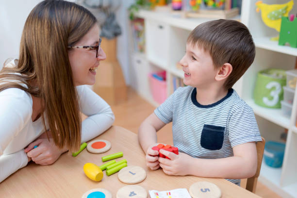 istock Proud mother looking at her son playing didactic games learning 669078494