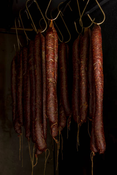 istock Smoked sausages hanging in smokehouse 669081128