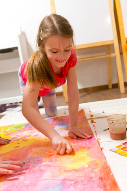 istock Girl draws home sitting on floor 669082002