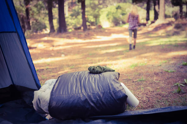 istock Sleeping bag in front of blonde camper walking away 669090840