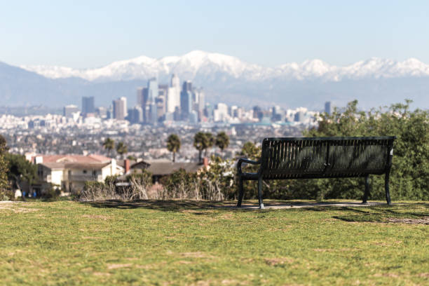 Snowed peaks mountains and downtown Los Angeles cityscape