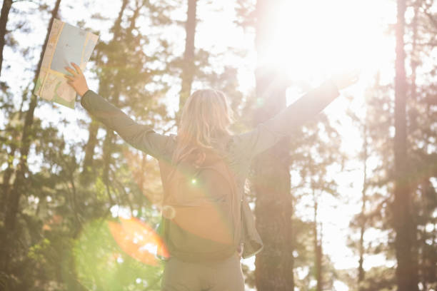 istock Carefree blonde hiker with arms outstretched 669091866