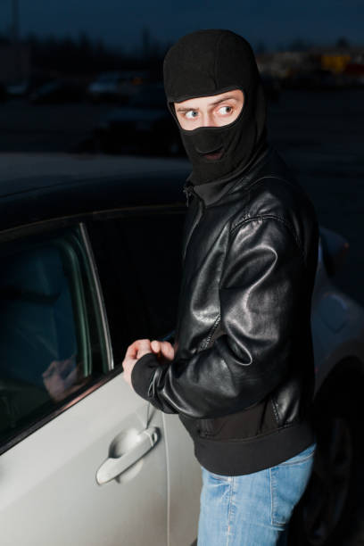 istock Male thief hands open car door with screwdriver 669092356