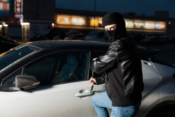 istock Male car thief open door with jemmy 669092382