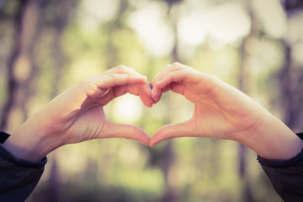 istock Carefree female hiker framing heart with hands 669092384