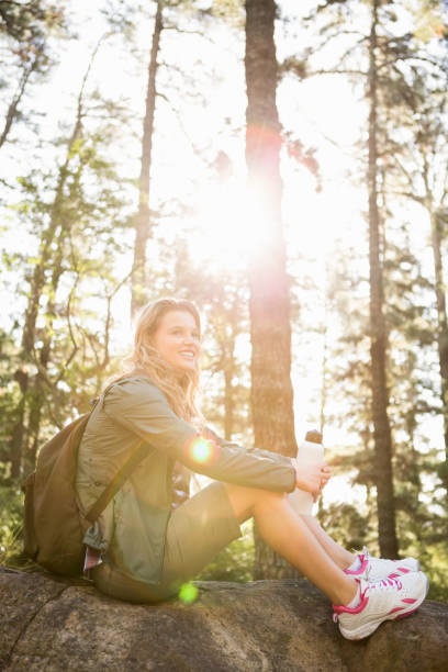 istock Pretty blonde hiker sitting on stone 669094450