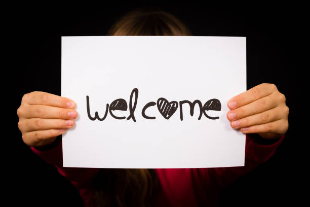 istock Child holding Welcome sign 669097980
