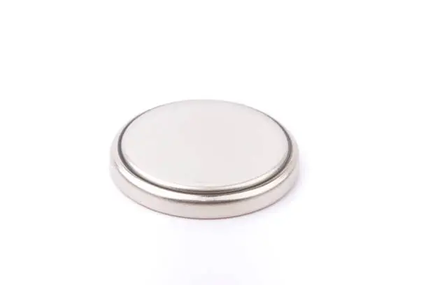 Photo of Small button battery isolated on white background.