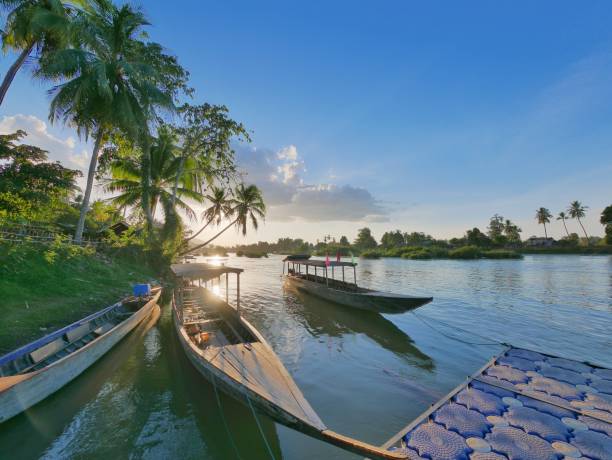 istock Long tail boats on the calm mekong river during sunset 669105896