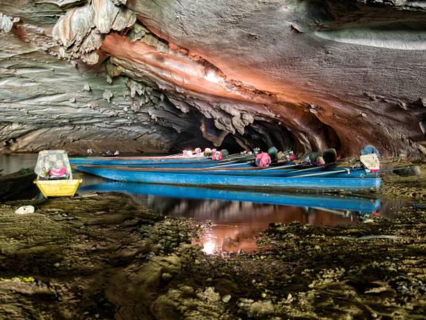 istock Long tail boats inside konglor cave in Laos 669105900