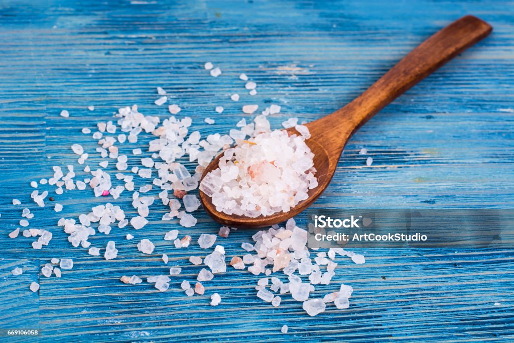 Large pink sea salt on blue background Large pink sea salt on blue background. Studio Photo Salt - Seasoning Stock Photo