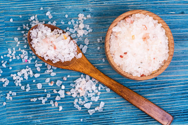 Large pink sea salt on blue background