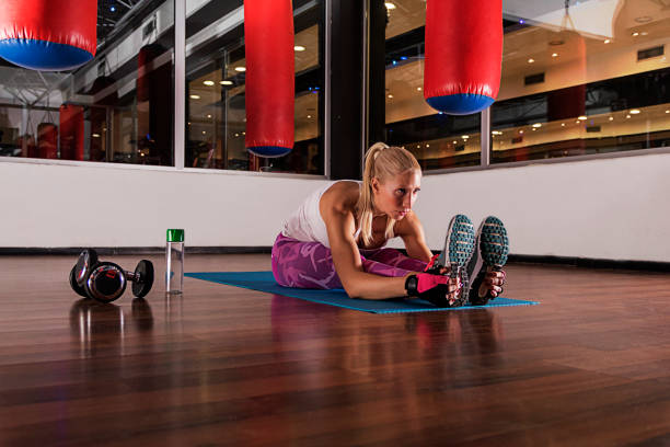 istock Woman exercising on yoga mat 669111240