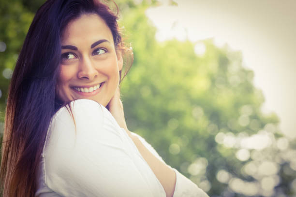 istock Beautiful brunette in the park 669115190