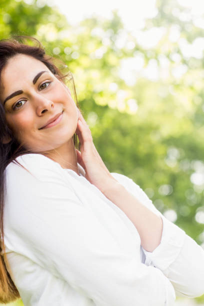 istock Beautiful brunette in the park 669115206