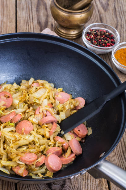 istock Sour cabbage stewed with slices of sausages 669115286