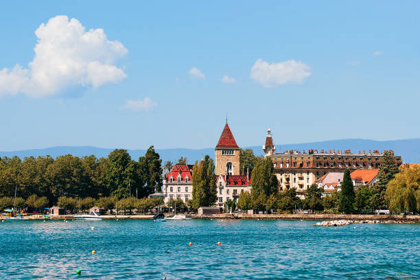 Chateau Ouchy and Lake Geneva quay in Lausanne Lausanne, Switzerland - August 26, 2016: Chateau Ouchy and Lake Geneva quay in Lausanne, Switzerland. People on the background lausanne quay of geneva lake stock pictures, royalty-free photos & images