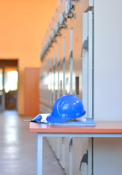 istock Work helmet on blueprints in electrical room 669118156