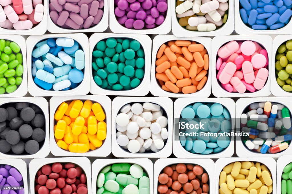 Assorted pills Varieties of multicolored pills inside plastic container Pill Stock Photo
