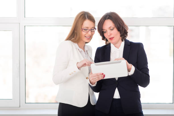 istock Businesswomen working together on digital tablet 669121560