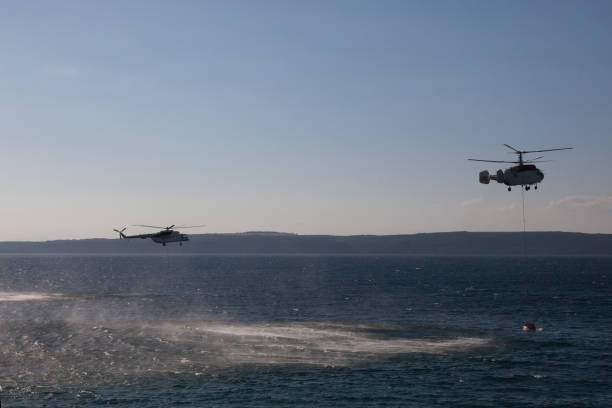 istock Firefighting Helicopter with Water Bucket on Sea 669125656