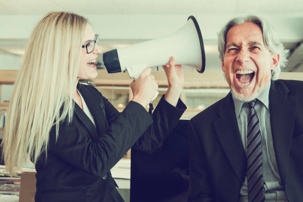 listen to my ideas! businesswoman shouting with megaphone to senior manager - instant print transfer audio imagens e fotografias de stock