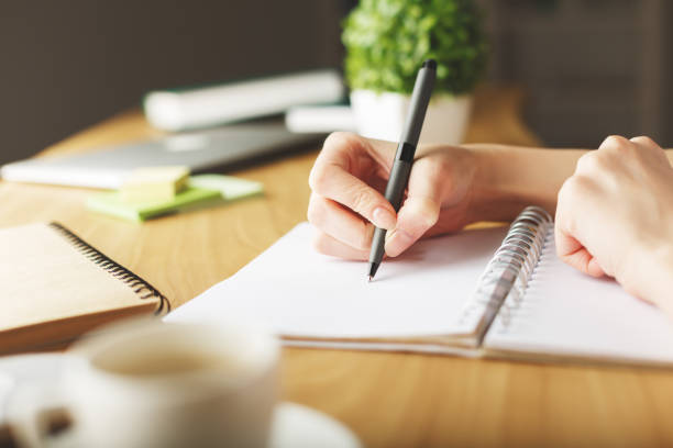 istock Girl doodling in notepad 669135110