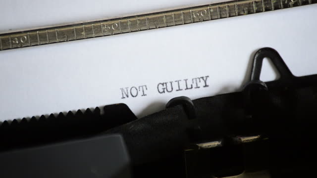 Typing the expression NOT GUILTY with an old manual typewriter