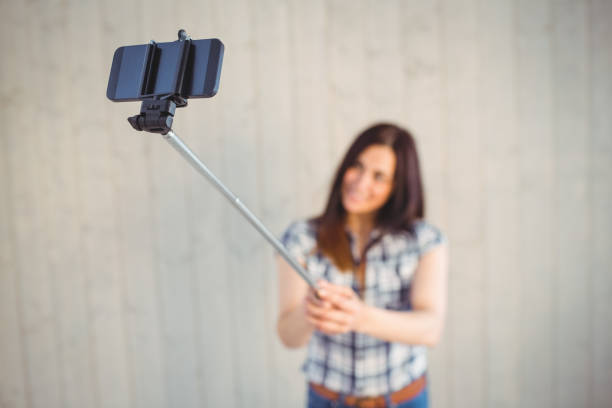 istock Pretty hipster taking a selfie with stick 669138510