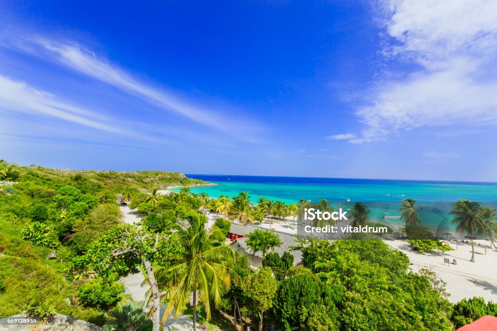 amazing view of Holguing province tropical inviting beach and tranquil azure turquoise ocean on blue sky background stunning gorgeous beautiful, amazing view of Holguing province tropical inviting beach and tranquil azure turquoise ocean on blue sky background Holguín Province Stock Photo