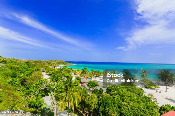 Amazing View Of Holguing Province Tropical Inviting Beach And Tranquil Azure Turquoise Ocean On Blue Sky Background Stock Photo - Download Image Now