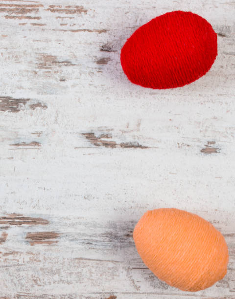 istock Easter eggs wrapped woolen string on wooden background, copy space for text, decoration for Easter 669166892
