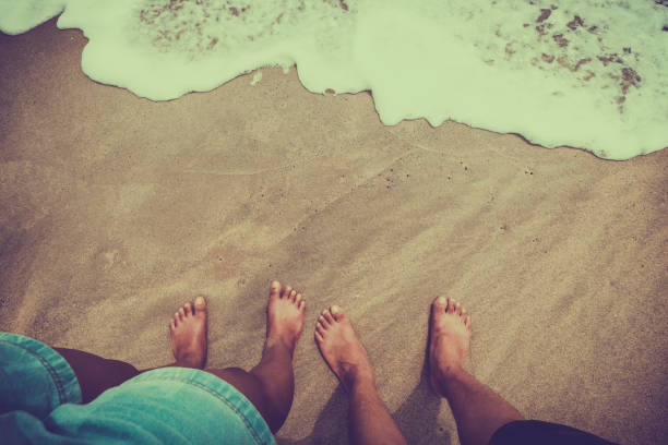istock couple are standing on the sandy beach 669167582