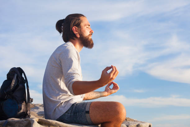 istock Young traveler meditating in nature 669173508