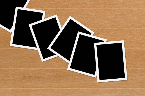 istock Blank photos on Wooden Table Background 669173960