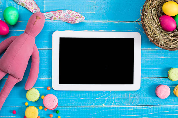 istock Colorful easter egg in nest on blue wood board 669181560
