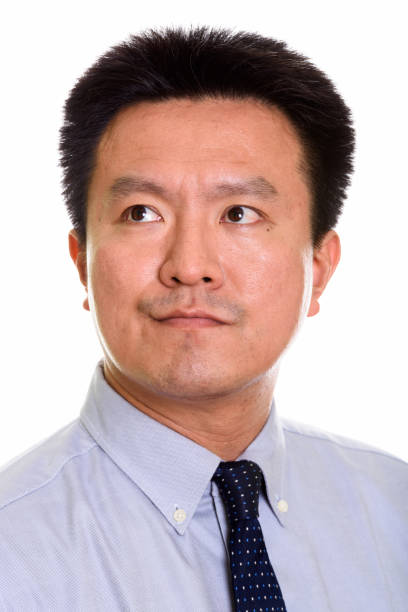 istock Face of Japanese businessman thinking while looking up 669184020