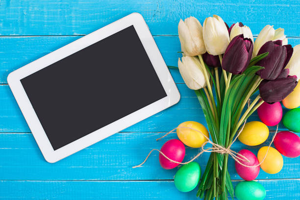 istock Easter eggs and tulips on blue rustic wooden planks 669184292