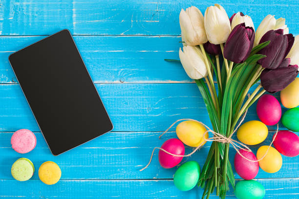 istock Easter eggs and tulips on blue wooden planks 669184328